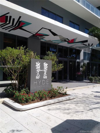 Front view of a modern building with a decorative canopy and signage.