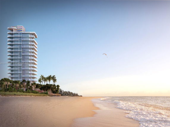 Front view of a modern beachfront high-rise building with multiple balconies.