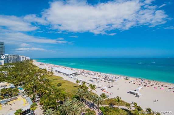 Wide view of a coastal area with beachfront buildings and the ocean.