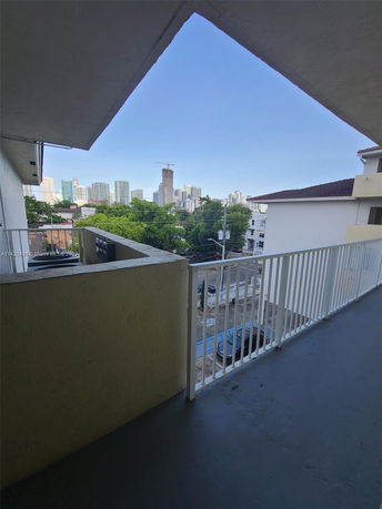 View from a balcony overlooking a city skyline.
