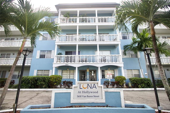 Front view of a multi-story residential building with balconies.