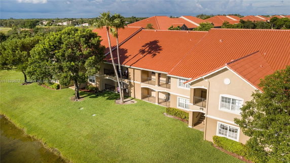 Front view of a two-story building with red tiled roof and balconies.