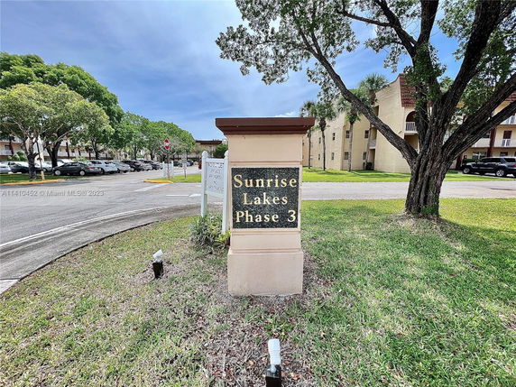 Outdoor view of a residential complex entrance with a sign reading 'Sunrise Lakes Phase 3'.