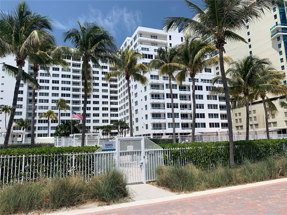 Front view of a multi-story residential building with balconies.