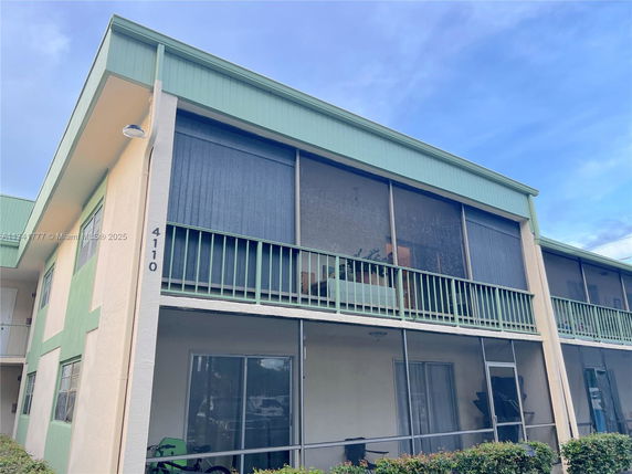 Front view of a two-story apartment building with balconies.
