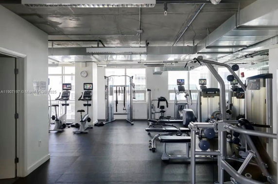 Indoor gym area with exercise equipment.