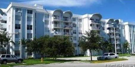 Front view of a multi-story apartment building with balconies.