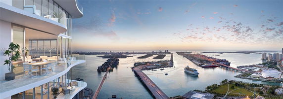 Wide angle view from a high-rise building overlooking a bay with a cruise ship and city skyline.