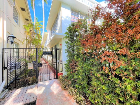 Front view of a modern building with a gated entrance.