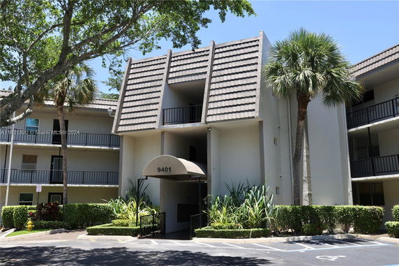 Front view of a multi-story building with a covered entrance.