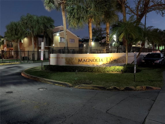 Front view of a residential building with a sign saying Magnolia Lane.