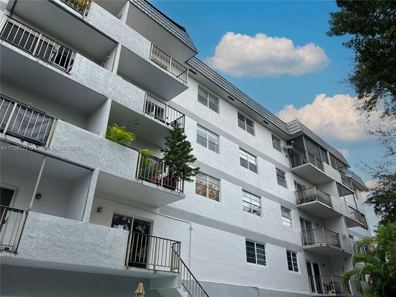 Front view of a multi-story residential building with balconies.