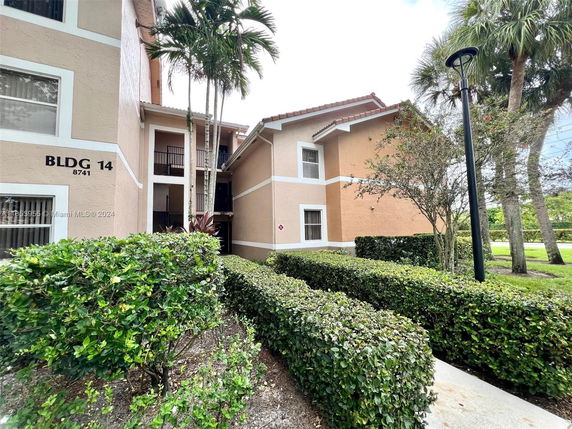 Front view of a multi-story building labeled BLDG 14 with balconies.