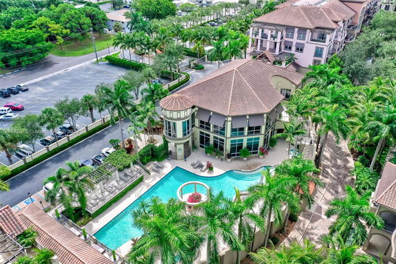 Elevated view of a residential or resort complex with a swimming pool and lush landscaping.