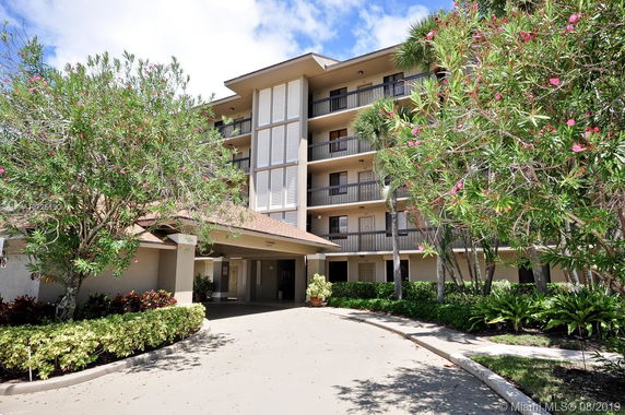 Front view of a multi-story residential building with balconies.