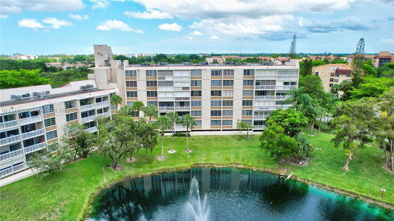 Front view of a multi-story apartment building with balconies.