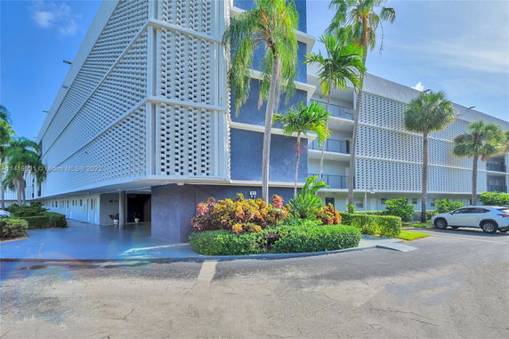 Front view of a multi-story building with decorative lattice exterior.