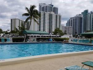 View of a swimming pool with high-rise buildings in the background.