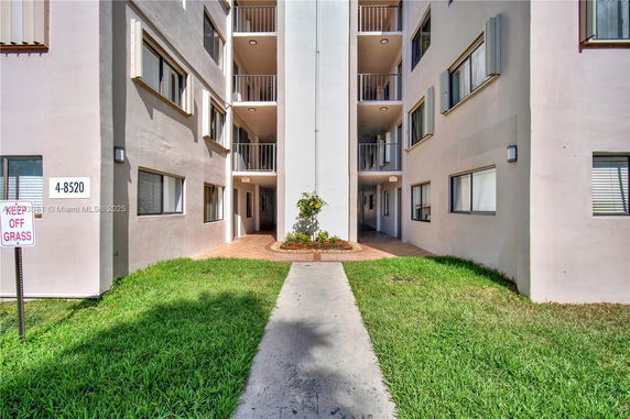 Front view of a multi-story residential building with balconies.