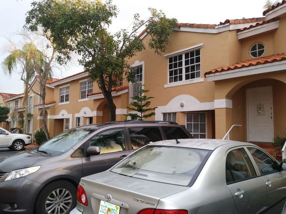 Front view of a two-story building with a row of identical units.