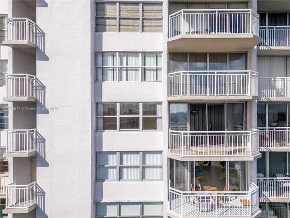 Close-up view of a residential building exterior with multiple balconies.