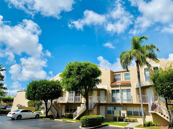 Front view of a multi-story residential building with balconies.