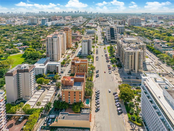 Aerial view of a cityscape with multiple tall buildings and streets.