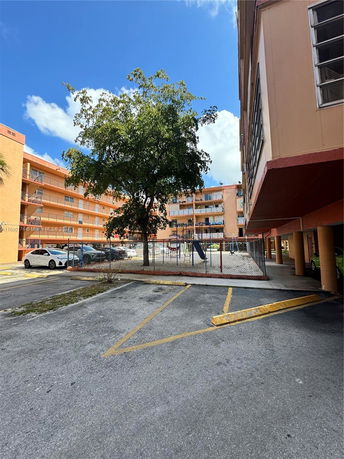 View of an outdoor play area near an apartment building.