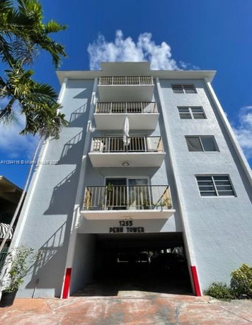 Front view of a multi-story building with balconies.