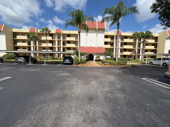 Front view of a multi-story residential building with balconies.