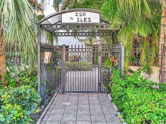Front gate of a building with greenery and an archway labeled '250 The Isles'.
