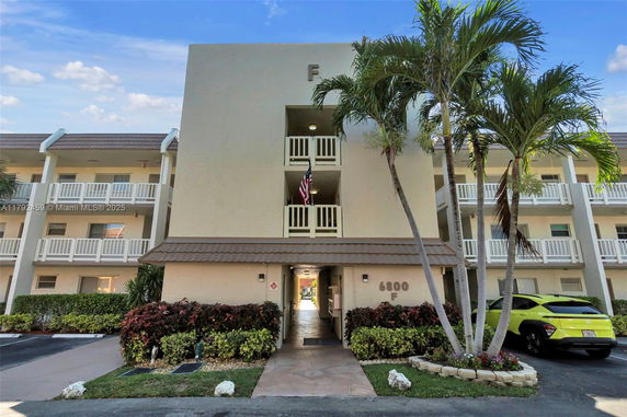 Front view of a multi-story residential building with balconies.