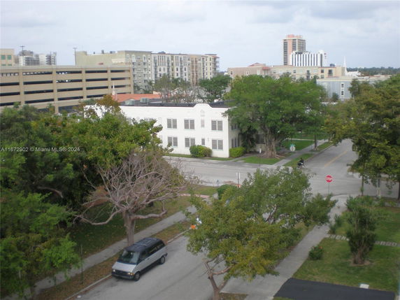 Aerial view of an urban area with residential and commercial buildings.
