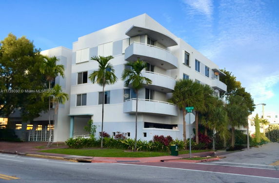 Front view of a multi-story residential building with balconies.