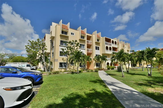 Front view of a multi-story apartment building with balconies.