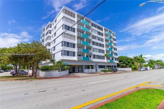 Front view of a multi-story apartment building with balconies.