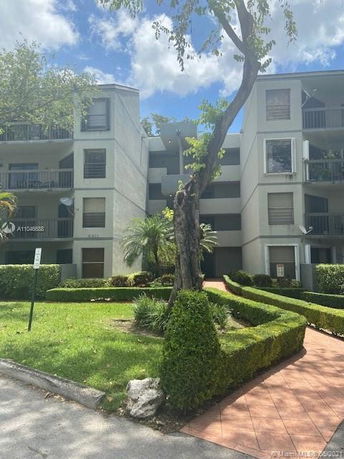 Front view of a multi-story residential building with balconies.