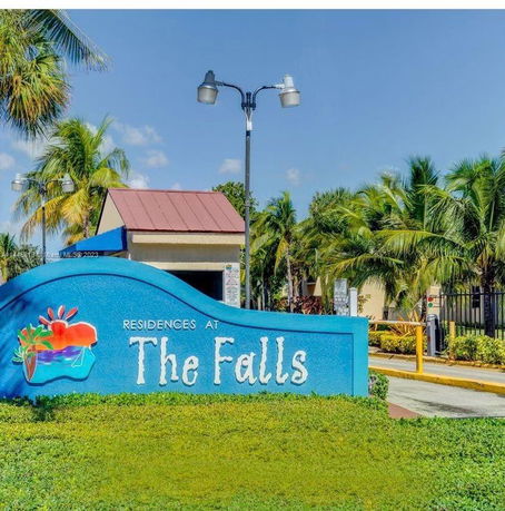 Front view of a building with a sign for 'Residences at The Falls'.