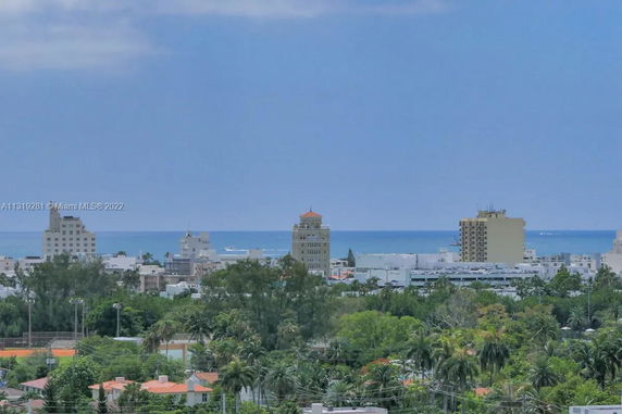 Cityscape view with ocean in the background and several tall buildings visible.