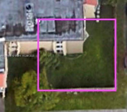 Aerial view of a building rooftop with solar panels.