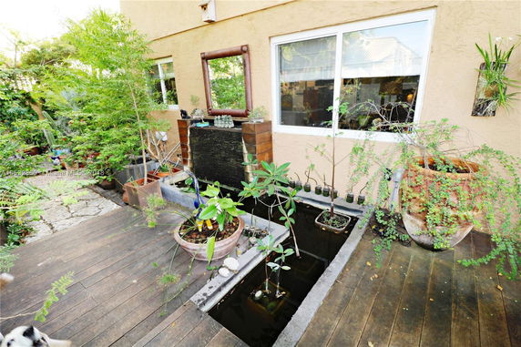 Front view of a house with a decorative garden and water feature.