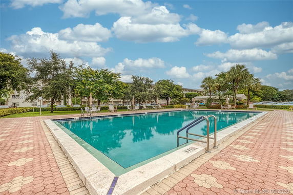 Outdoor swimming pool with surrounding deck and trees