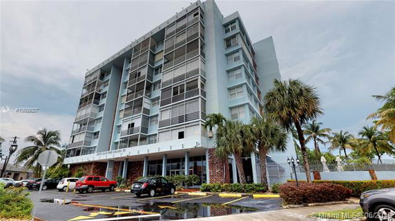 Front view of a multi-story residential building with balconies.