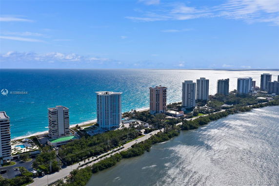 Panoramic view of multiple high-rise buildings along a coastline with the ocean in the background.