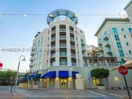 Front view of a multi-story building with blue awnings.