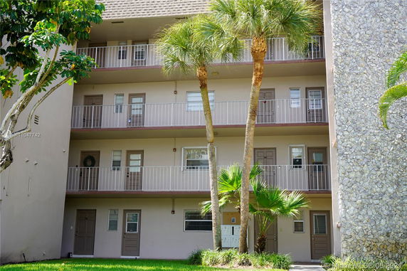 Front view of a multi-story residential building with balconies.