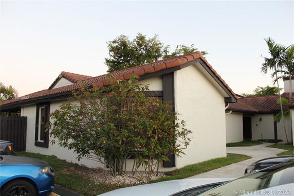 Front view of a single-story house with a red tile roof.