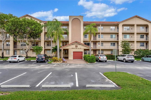 Front view of a multi-story residential building with balconies.