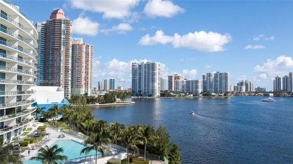 View of high-rise residential and commercial buildings near a waterfront with boats.