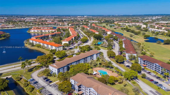 Aerial view of a residential area with multiple buildings and water bodies.